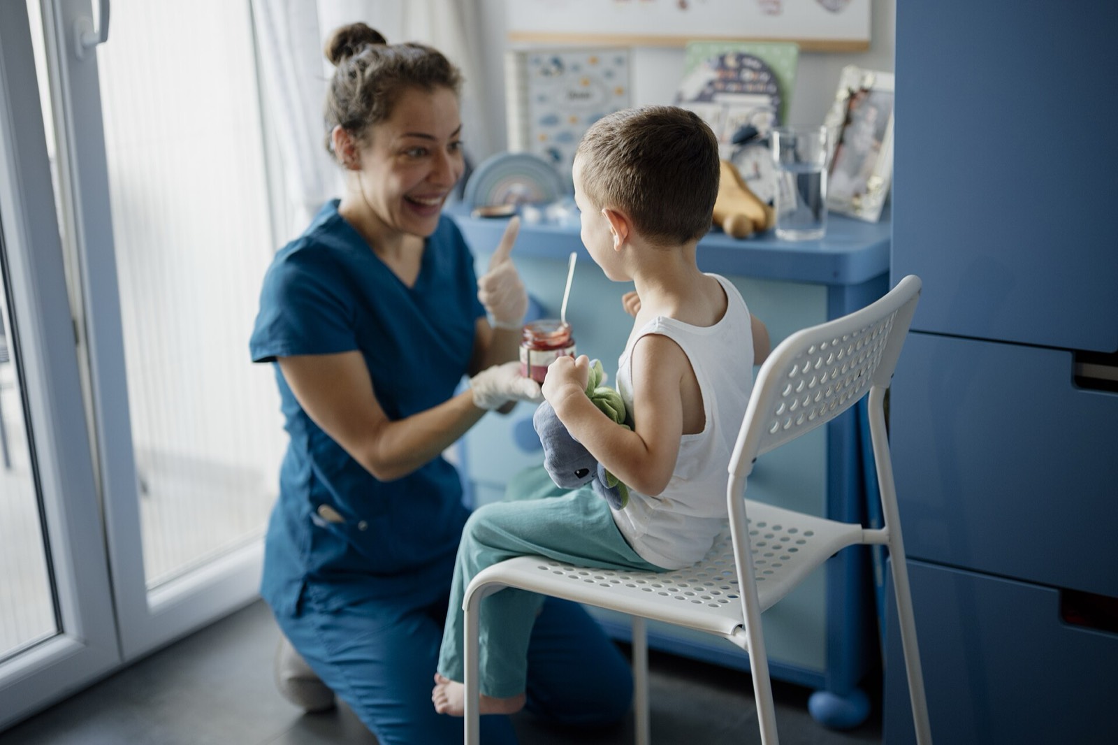 A dentist checking a young boy's teeth